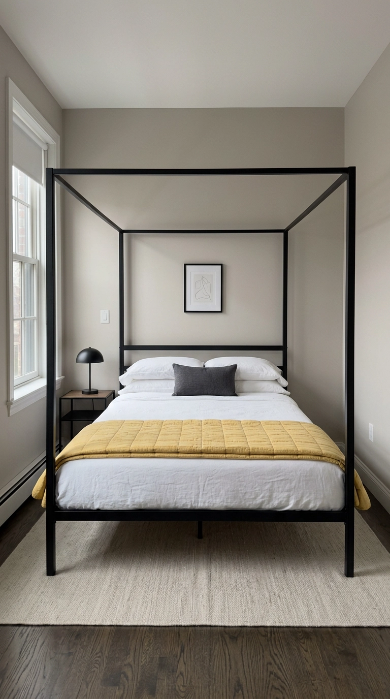 Sunflower yellow cotton quilt folded across the foot of a black four-poster bed